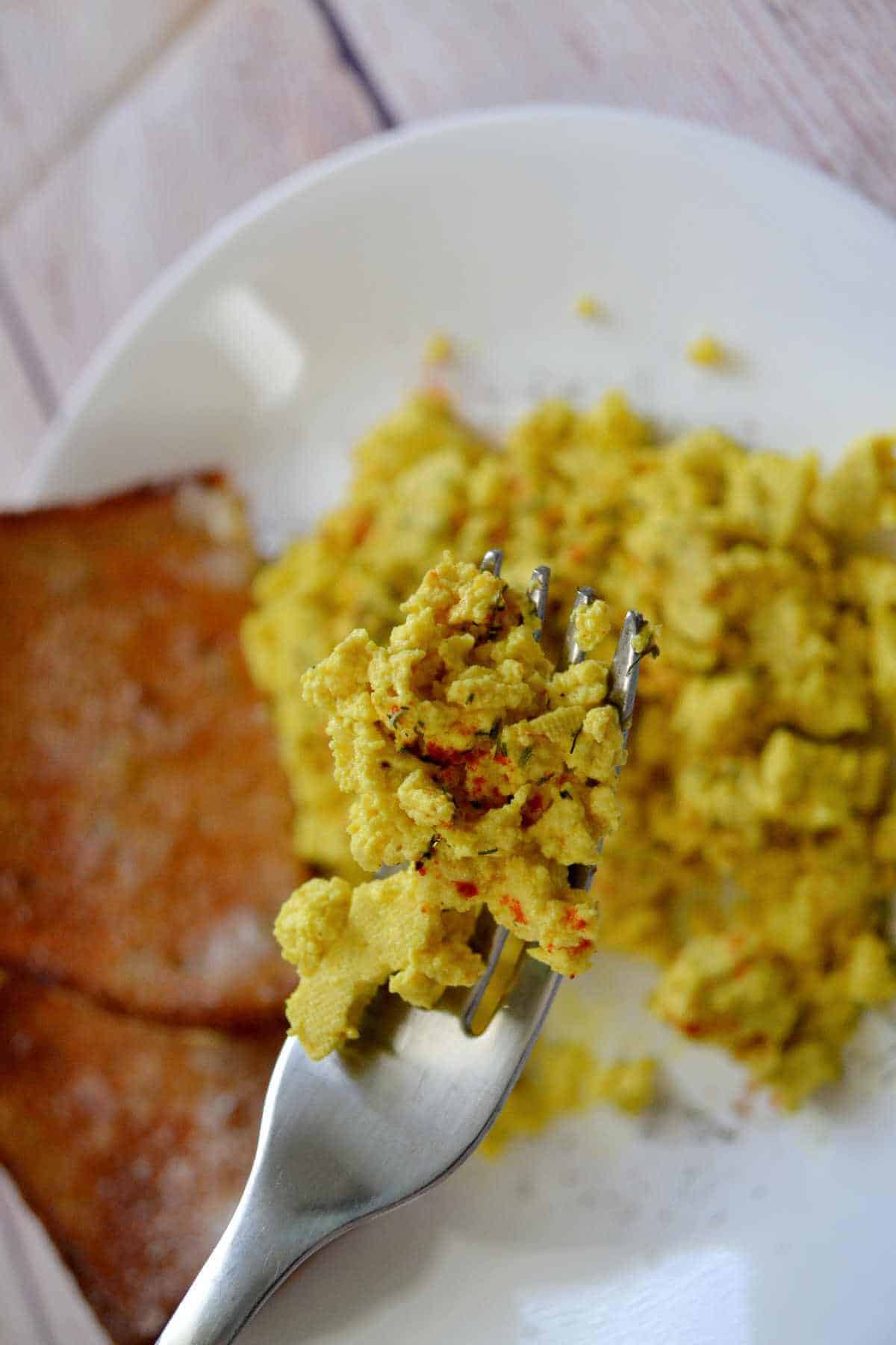 close up shot of scramble on a fork with background blurred out.