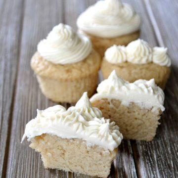 four cupcakes in view topped with icing.
