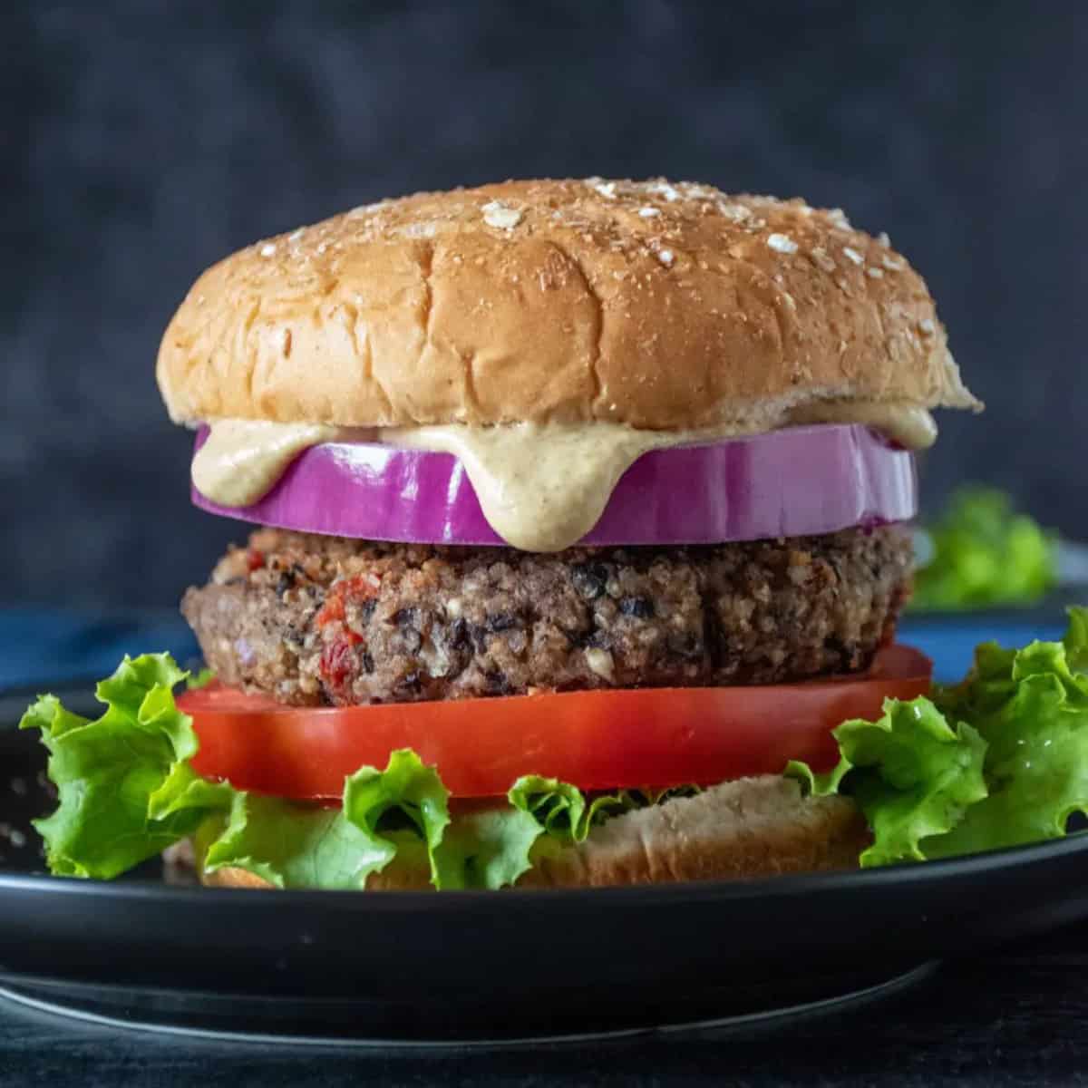 black bean burgers with sauce, tomato, onion and lettuce.