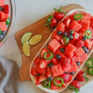 rectangular plate filled with watermelon, blueberries and jalapenos.