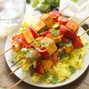 tofu skewers atop a bed of rice.