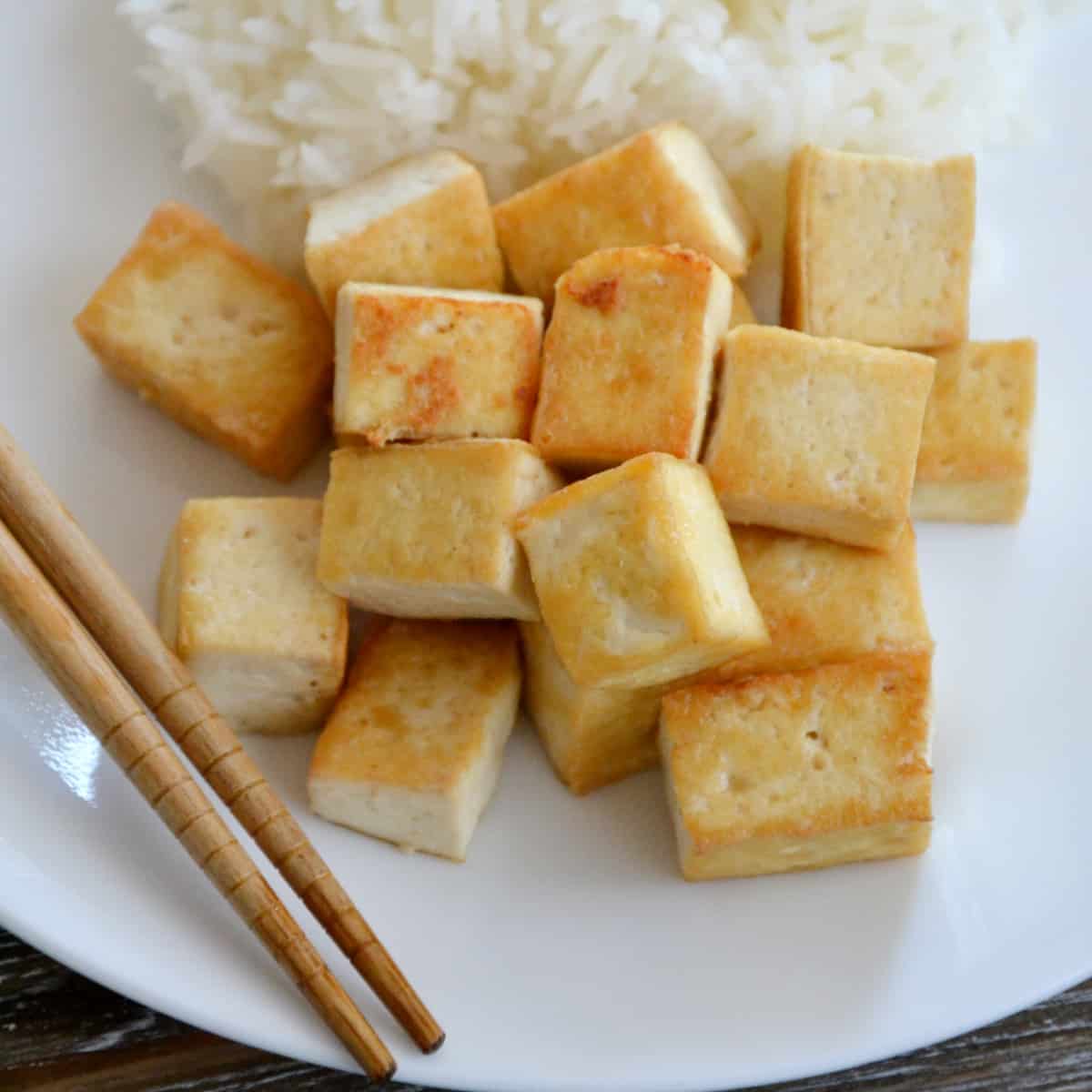 browned tofu beside rice.