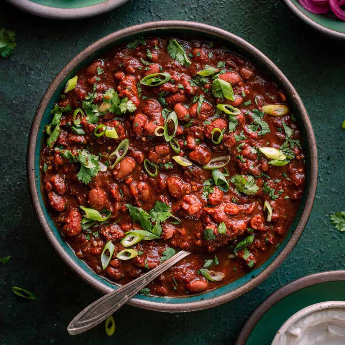 hearty chili in a bowl with a spoon.