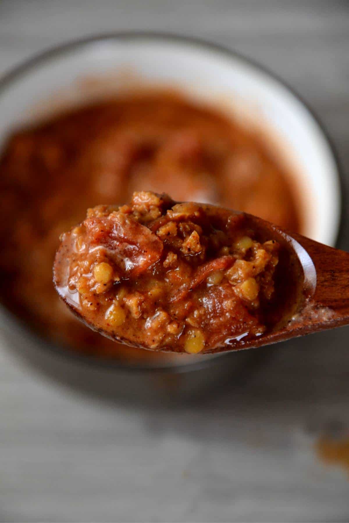 lentil chili on wooden spoon.