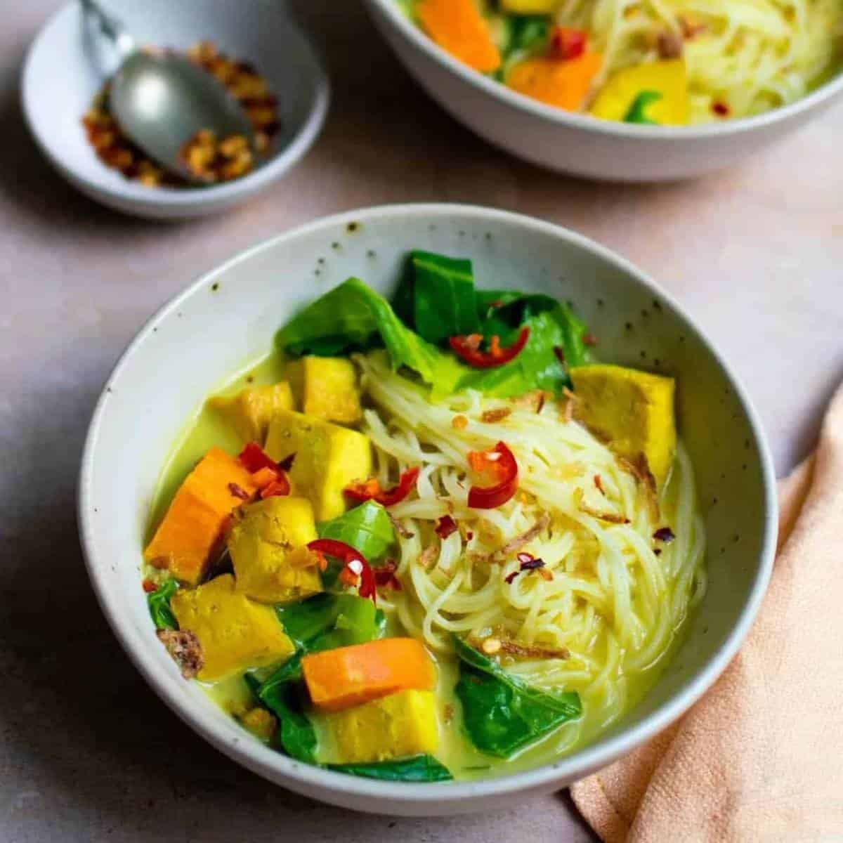 bright colored soup with noodles.