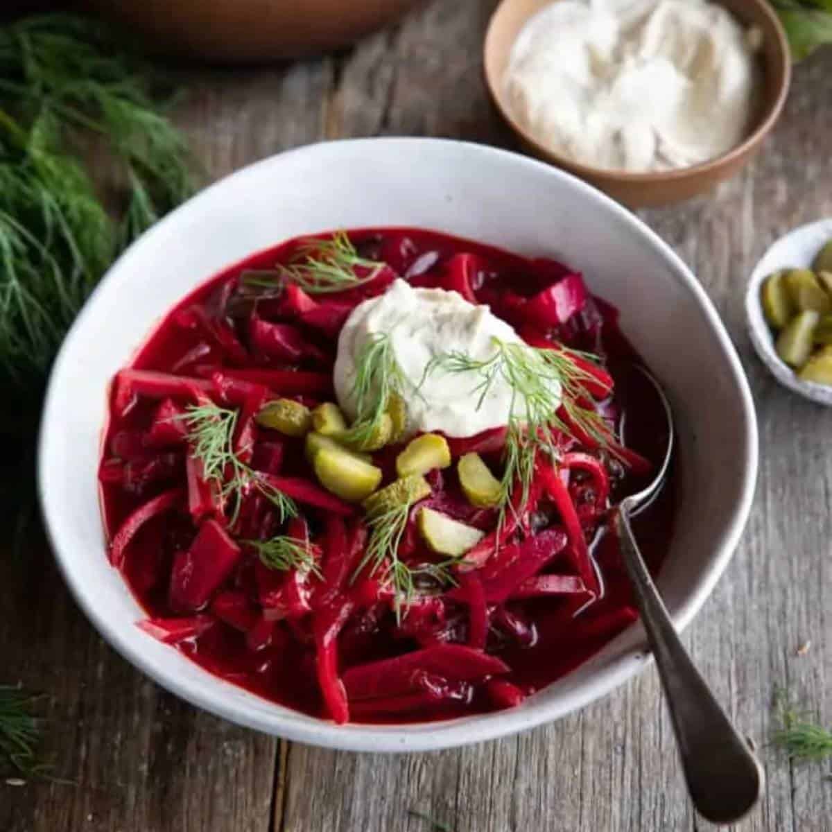 vibrant beets in broth topped with dill.