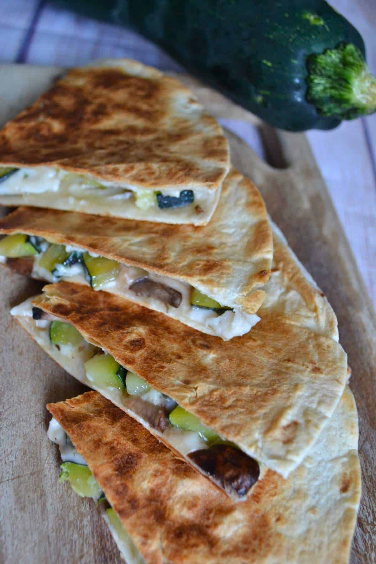 finished quesadillas with a whole zucchini in the background.