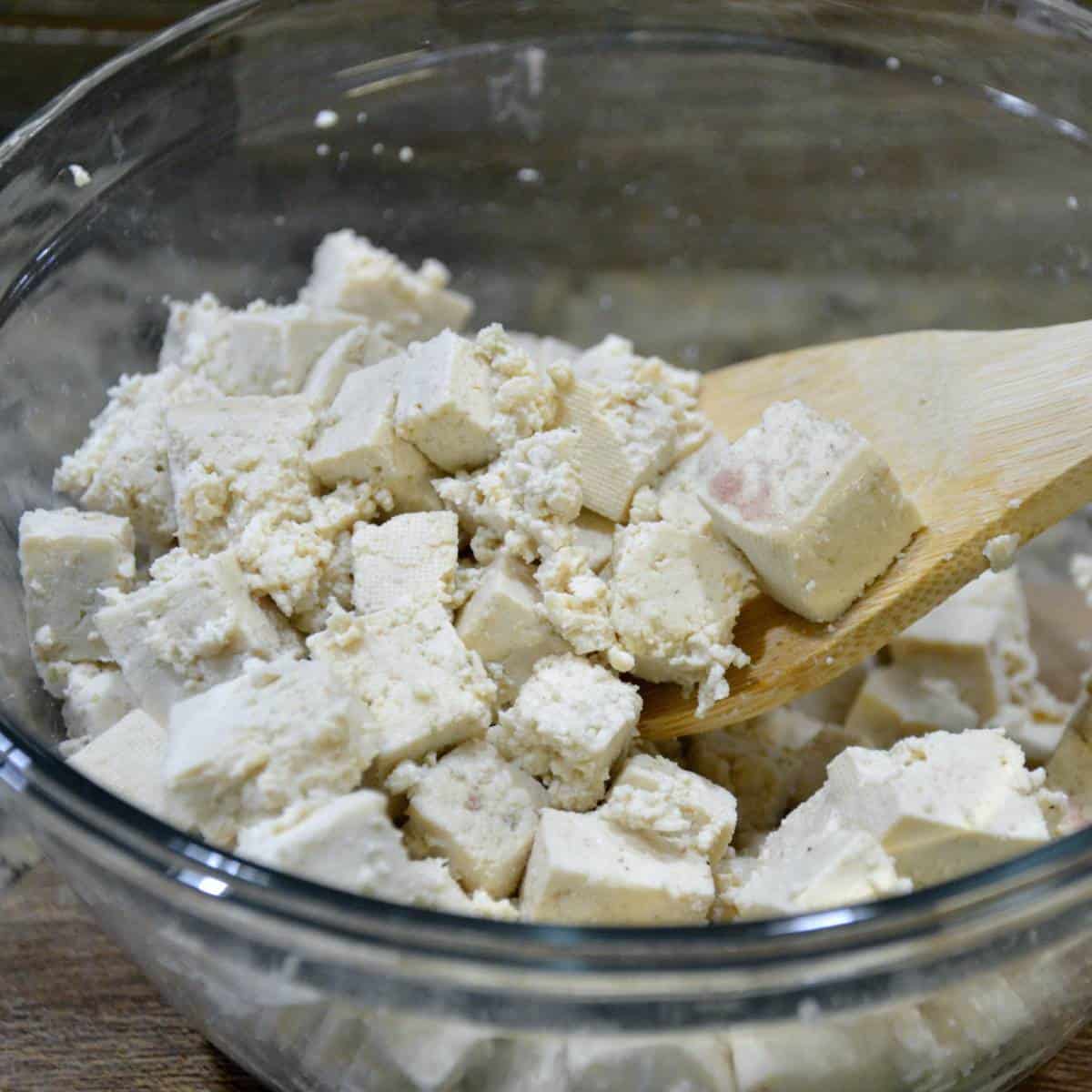 step one making tofu salad mixing the tofu and kala namak.
