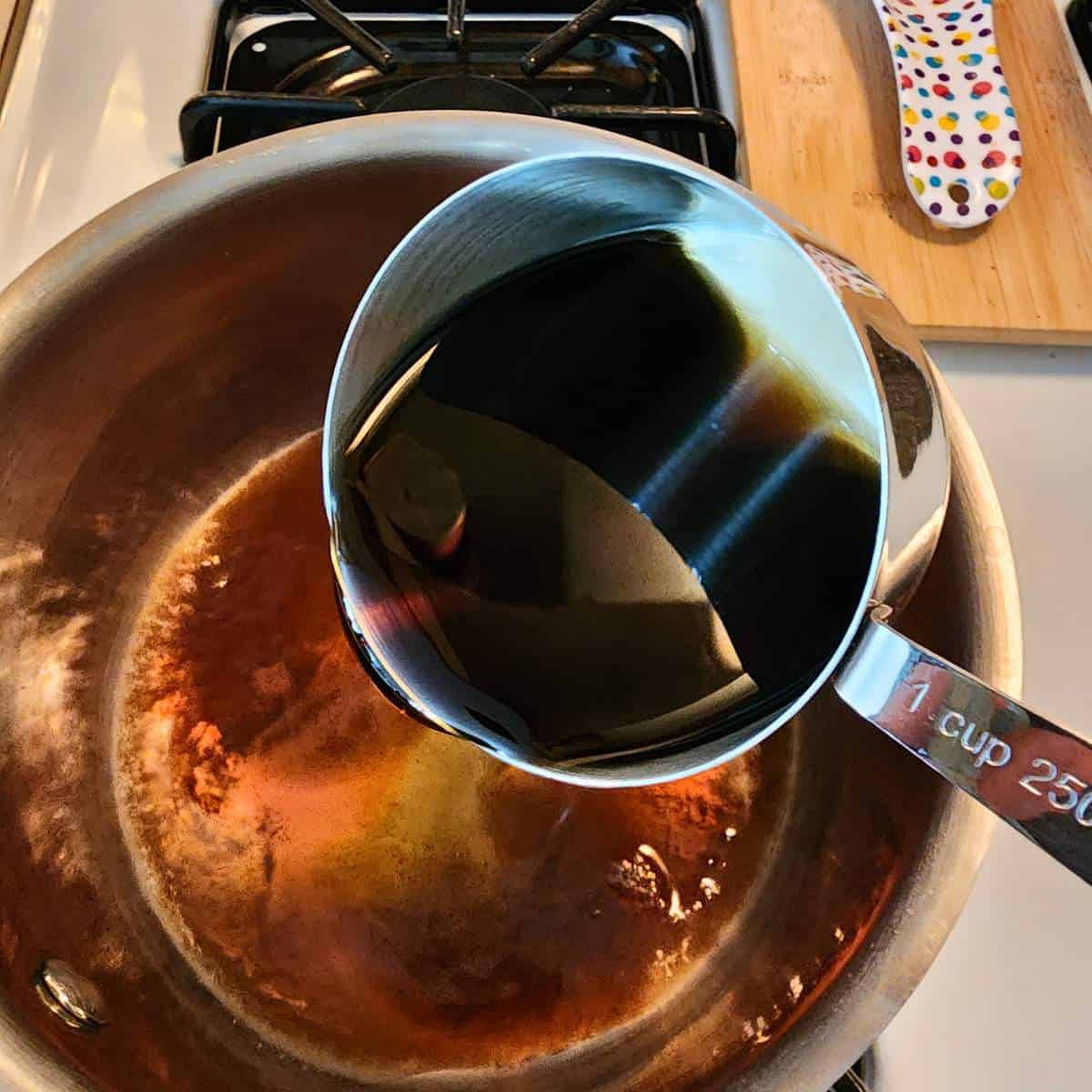 step one adding maple syrup to pan.