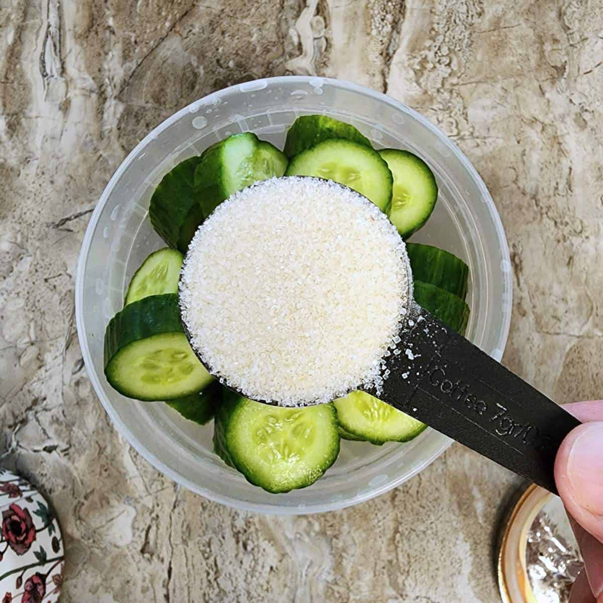 step two adding sugar to cucumbers.